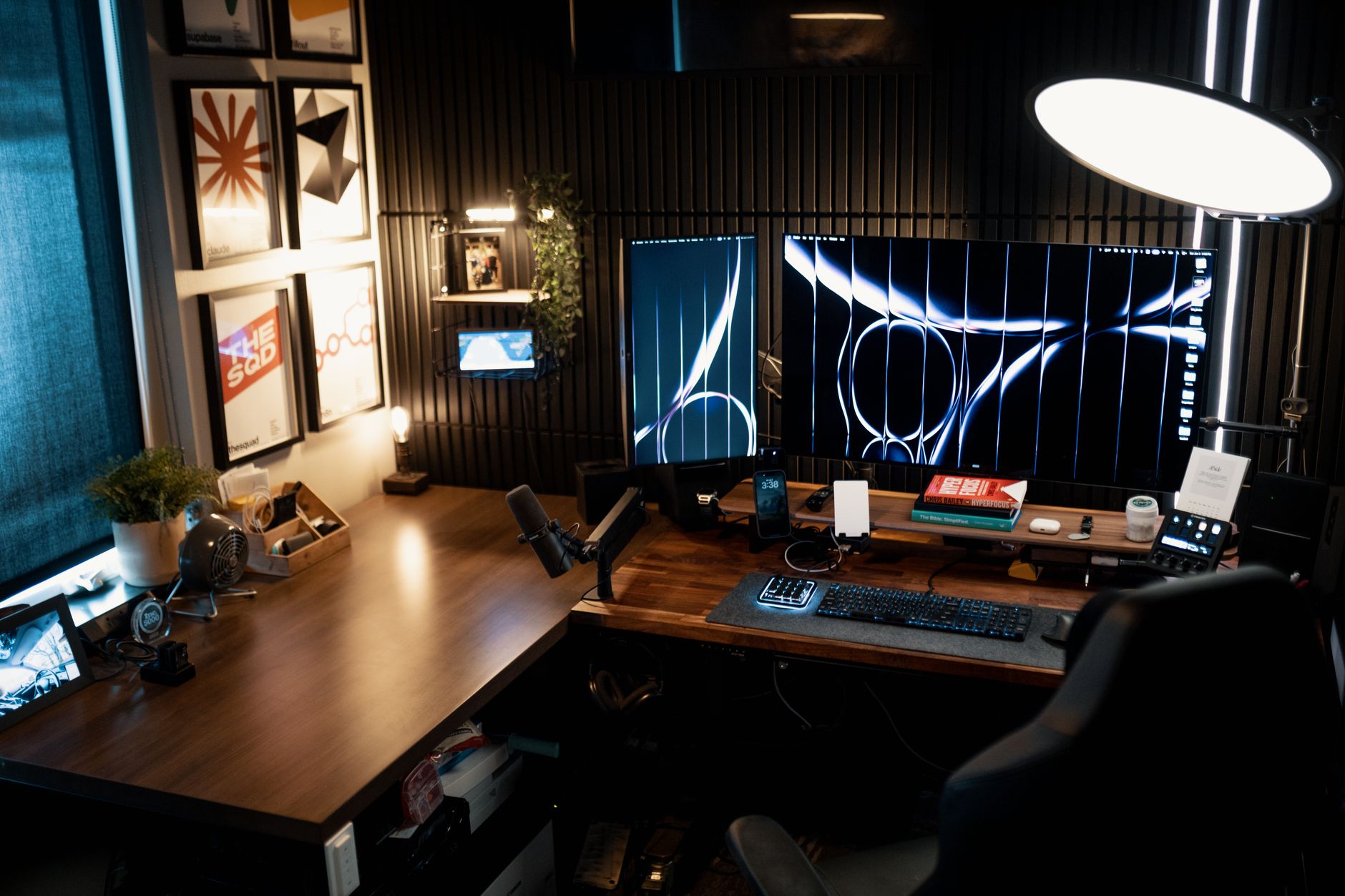L-shaped autonomous smart desk with two monitors and keyboard in corner office