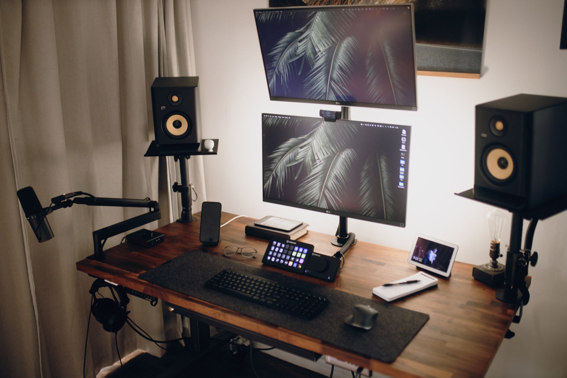 a person attaching a dual monitor arm to a home office desk