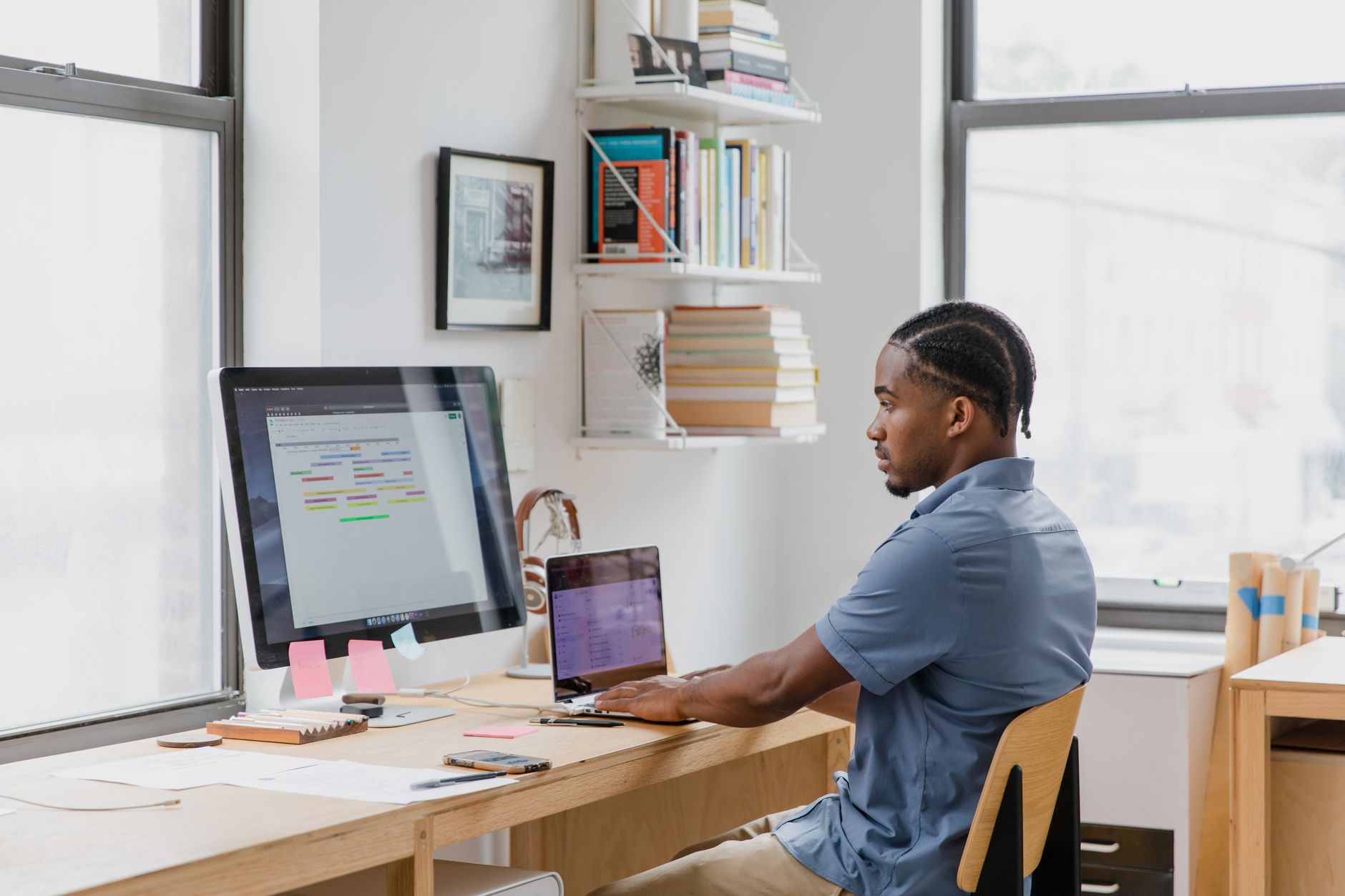 a person sitting at a desk with two monitors positioned in a shallow arc