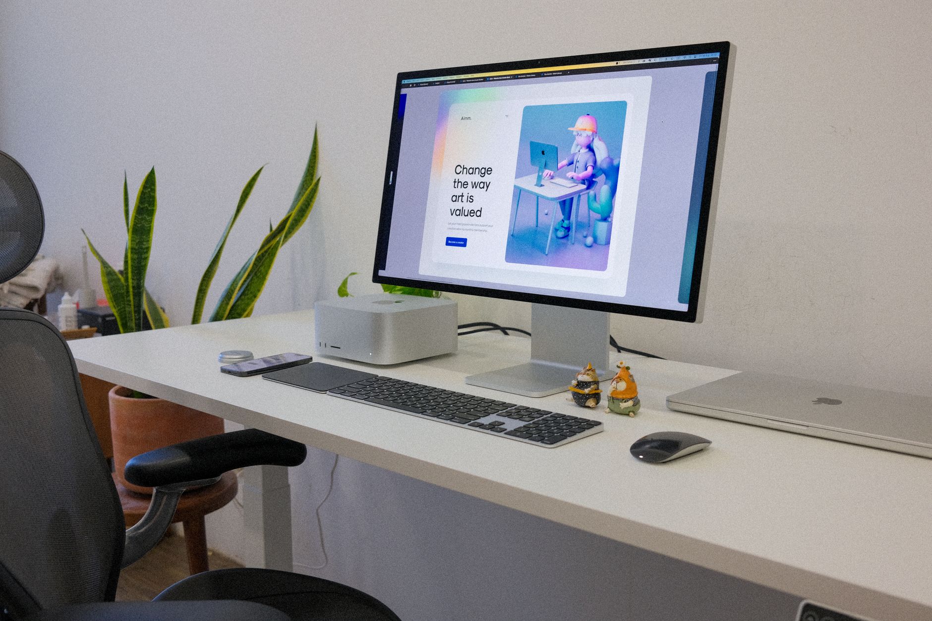 Standing desk converter with raised monitor on a white office desk