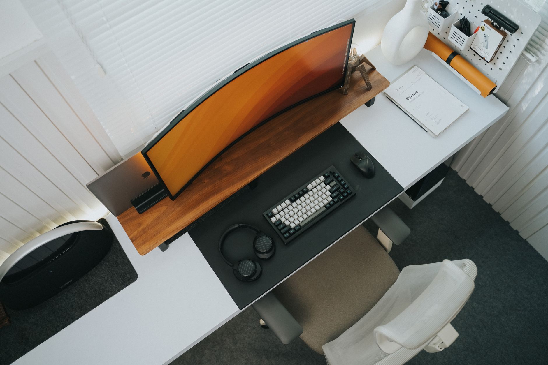Under desk steel cable tray mounted beneath a white sit-stand desk holding black cables