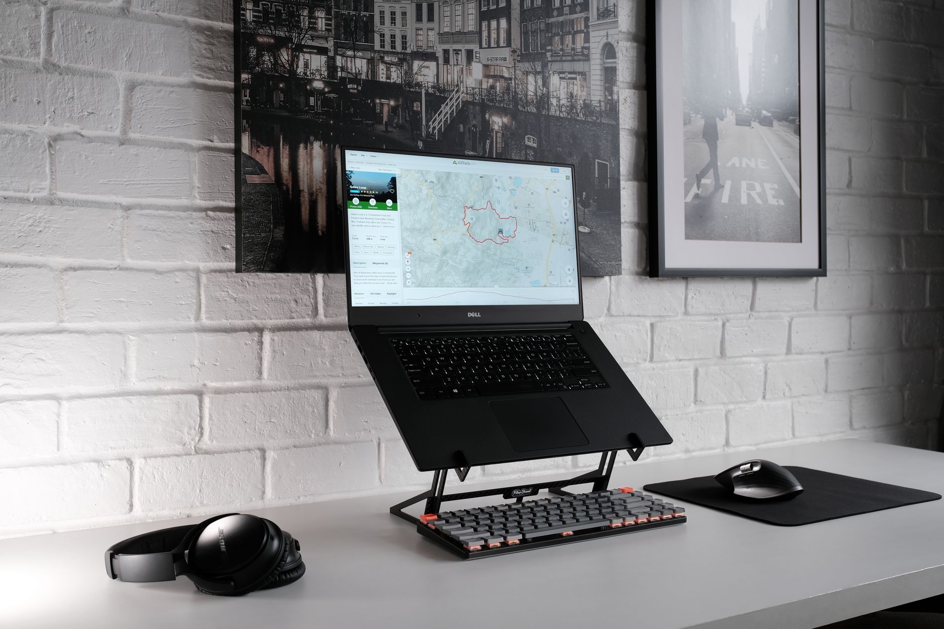 Compact standing desk converter with laptop and keyboard on wooden desk