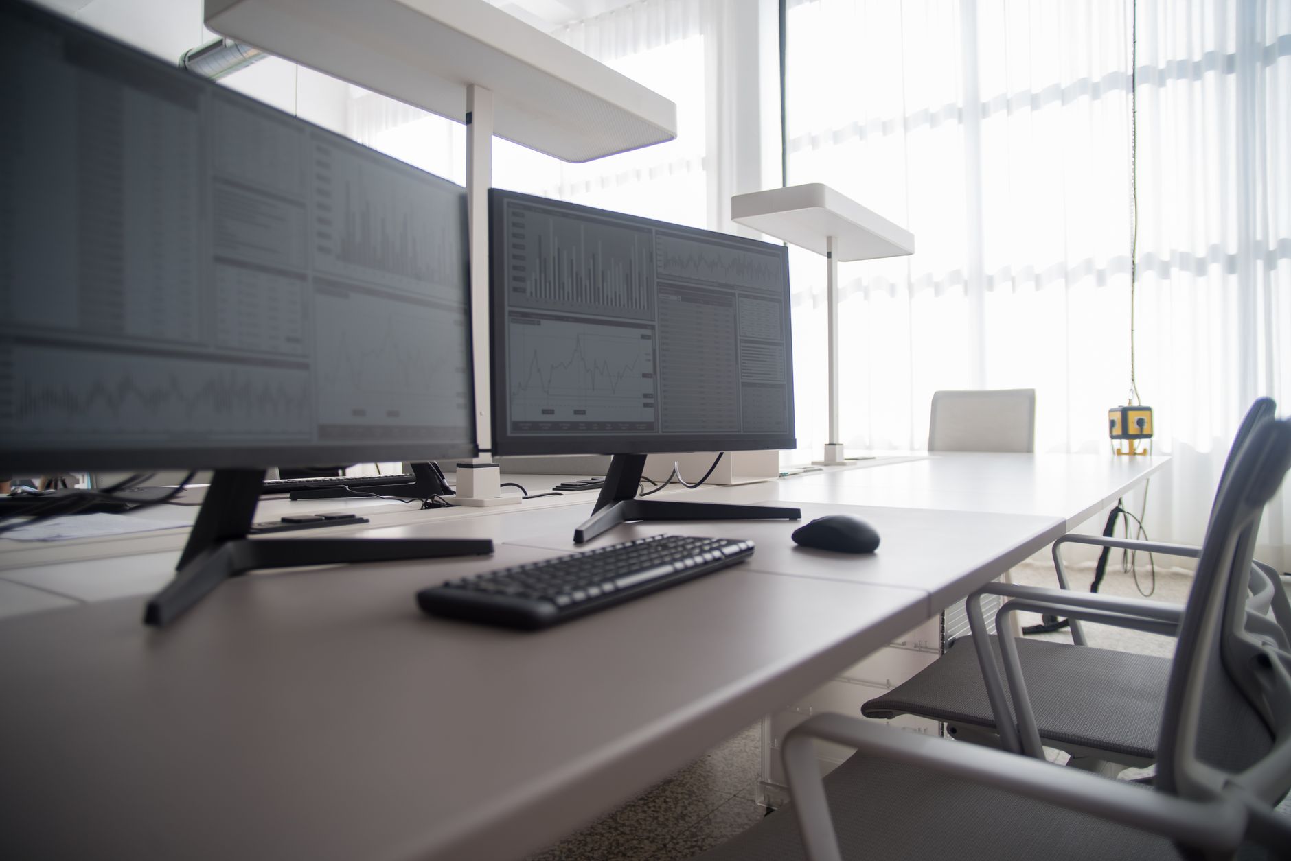 a well adjusted ergonomic workstation with chair armrests, monitor at eye level, and keyboard close to the body